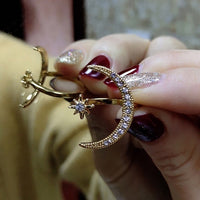 Moon-shaped ring studded with zircon crystals